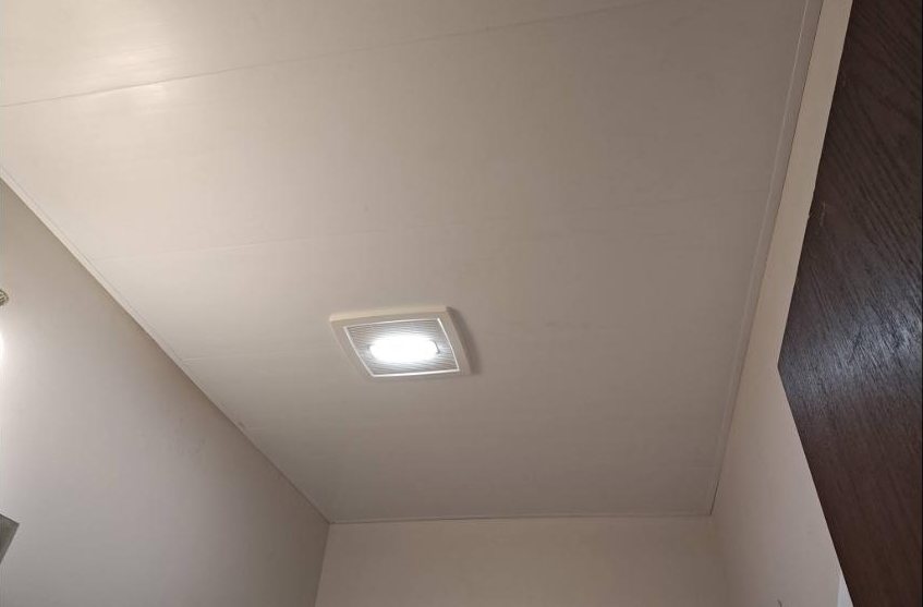 New ceiling panels and a fan-light fitted in a bathroom