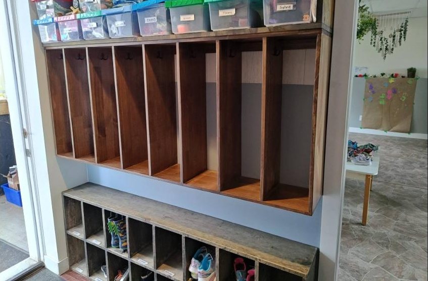 Row of built-in lockers with labelled bins above and shoe cubbies below